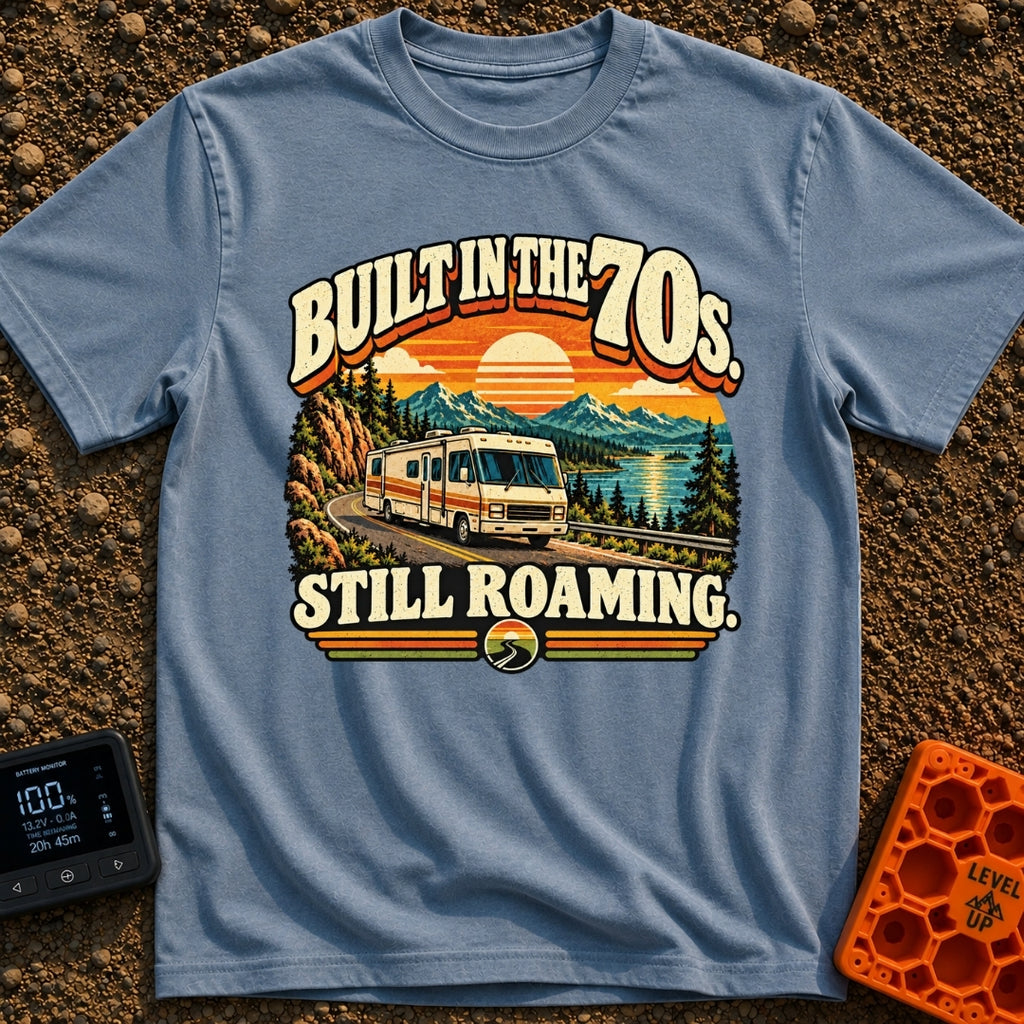 Born In A Barn - T-Shirt in Blue Jean - A retro-style illustration of a vintage Class A motorhome driving along a winding...