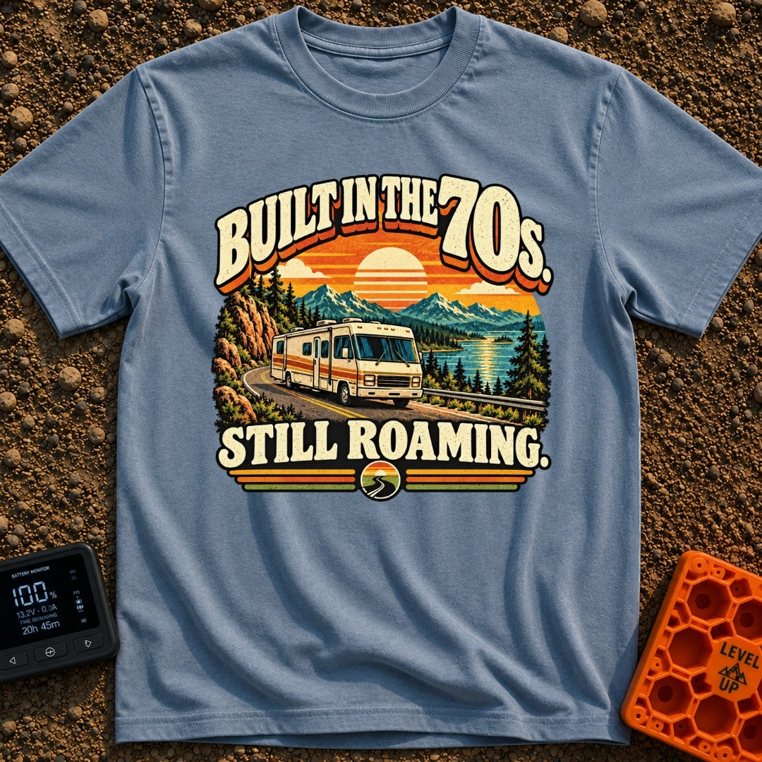 Born In A Barn - T-Shirt in Blue Jean - A retro-style illustration of a vintage Class A motorhome driving along a winding...