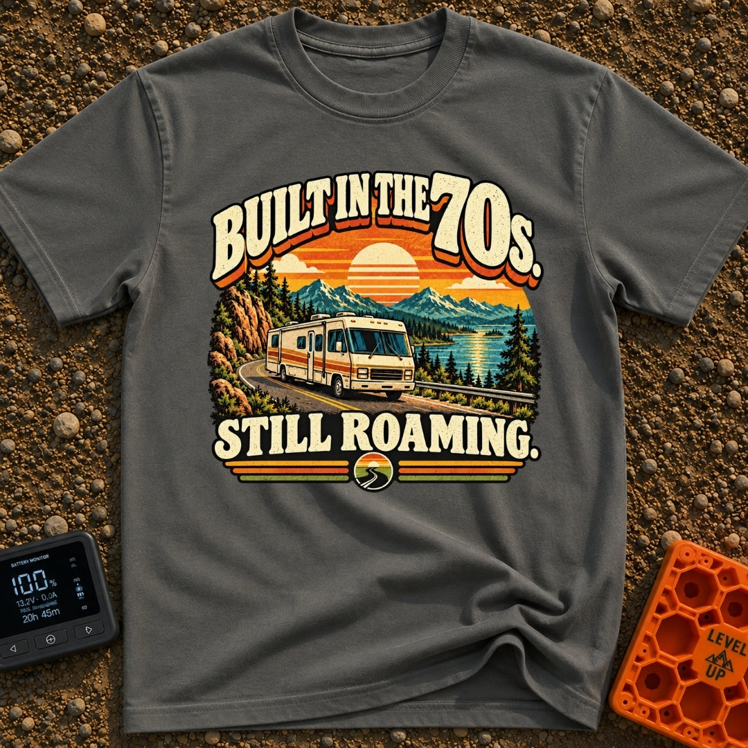 Born In A Barn - T-Shirt in Pepper - A retro-style illustration of a vintage Class A motorhome driving along a winding...