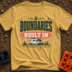 Boundaries Built In - T-Shirt in Mustard - A camper van is parked in front of mountains and pine trees with the text...