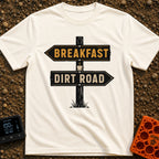 Breakfast Next Dirt Road - T-Shirt in Ivory - A graphic of a wooden directional signpost with two arrows; the top arrow...