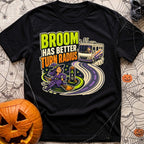 Brooms Turn Better - T-Shirt in Black - A cartoon illustration showing a witch flying effortlessly in a tight circle...