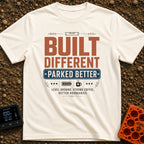 Built Different Parked - T-Shirt in Ivory - A typographic design reading 'BUILT DIFFERENT' and 'PARKED BETTER' in large...