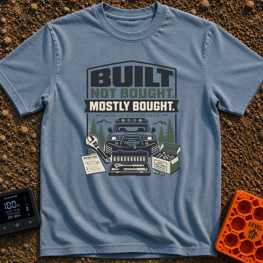 Built But Mostly Bought - T-Shirt in Blue Jean - A graphic illustration featuring an off-road 4x4 vehicle with a front...