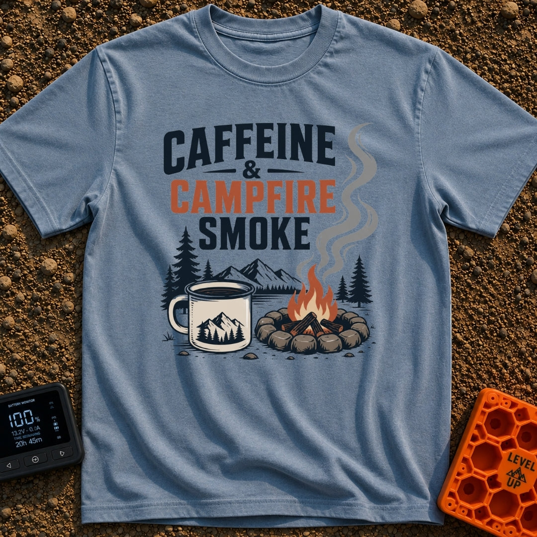 Caffeine And Campfires - T-Shirt in Blue Jean - A large camp mug filled with coffee next to a stone-ringed campfire with...