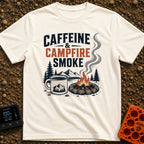 Caffeine And Campfires - T-Shirt in Ivory - A large camp mug filled with coffee next to a stone-ringed campfire with...