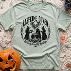 Wake The Coven - T-Shirt in Bay - A black and white circular illustration of three witches standing around a cauldron...