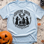 Wake The Coven - T-Shirt in Chambray - A black and white circular illustration of three witches standing around a...