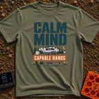 Calm And Capable - T-Shirt in Moss - A typographic graphic reading "CALM MIND" above a camper van parked in front of...