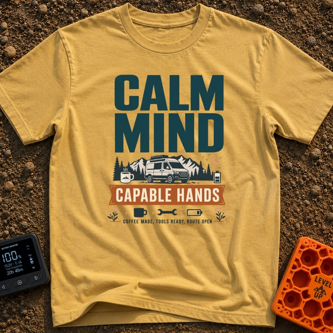 Calm And Capable - T-Shirt in Mustard - A typographic graphic reading "CALM MIND" above a camper van parked in front of...
