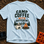Brew Hits Different - T-Shirt in Chambray - A graphic showing a steaming enamel camp mug next to a stone-ringed campfire,...
