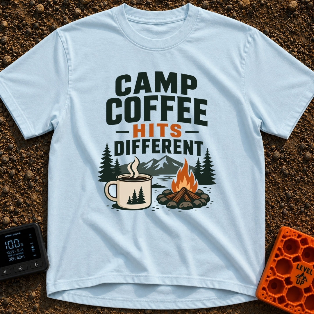 Brew Hits Different - T-Shirt in Chambray - A graphic showing a steaming enamel camp mug next to a stone-ringed campfire,...