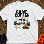 Brew Hits Different - T-Shirt in White - A graphic showing a steaming enamel camp mug next to a stone-ringed campfire,...