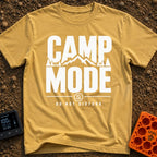 Camp Mode Activated - T-Shirt in Mustard - Bold typographic design reading "CAMP MODE" with a silhouette of mountains and...