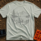 Paws-On Camp Setup - T-Shirt in Bay - A black and white line illustration of a man setting up a folding camp chair on the...
