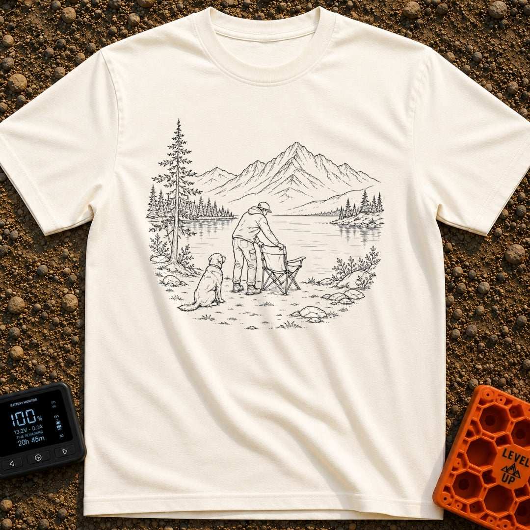 Paws-On Camp Setup - T-Shirt in Ivory - A black and white line illustration of a man setting up a folding camp chair on...