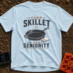 Skillet Has Seniority - T-Shirt in Chambray - A graphic illustration of a steaming cast-iron skillet next to a folded...