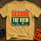 Secure The View - T-Shirt in Mustard - A typographic design featuring the text "CAMP STATUS:" alongside GPS coordinates,...