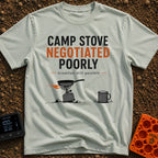 Stove Negotiations Failed - T-Shirt in Bay - A graphic of a small canister camp stove and frying pan tilting on uneven,...