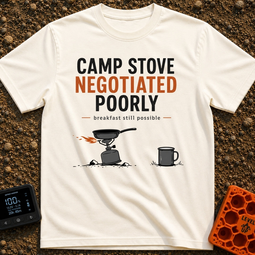 Stove Negotiations Failed - T-Shirt in Ivory - A graphic of a small canister camp stove and frying pan tilting on uneven,...