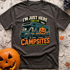 Unexplained Campfire Attendance - T-Shirt in Graphite - A skeleton throws a peace sign from the driver's window of a blue...