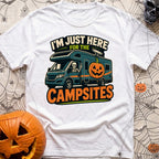 Unexplained Campfire Attendance - T-Shirt in White - A skeleton throws a peace sign from the driver's window of a blue...