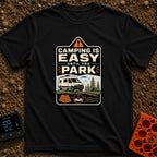 Easy Until You Park - T-Shirt in Black - A badge-style illustration showing a white campervan parked on uneven ground...