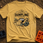 Campsite Dumpling Bureau - T-Shirt in Mustard - A badge-style illustration showing a camper van in the woods next to a...