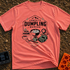 Campsite Dumpling Bureau - T-Shirt in Watermelon - A badge-style illustration showing a camper van in the woods next to a...