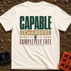 Charged To Roam Free - T-Shirt in Ivory - A typographic design featuring the words "CAPABLE CHARGED COMPLETELY FREE"...