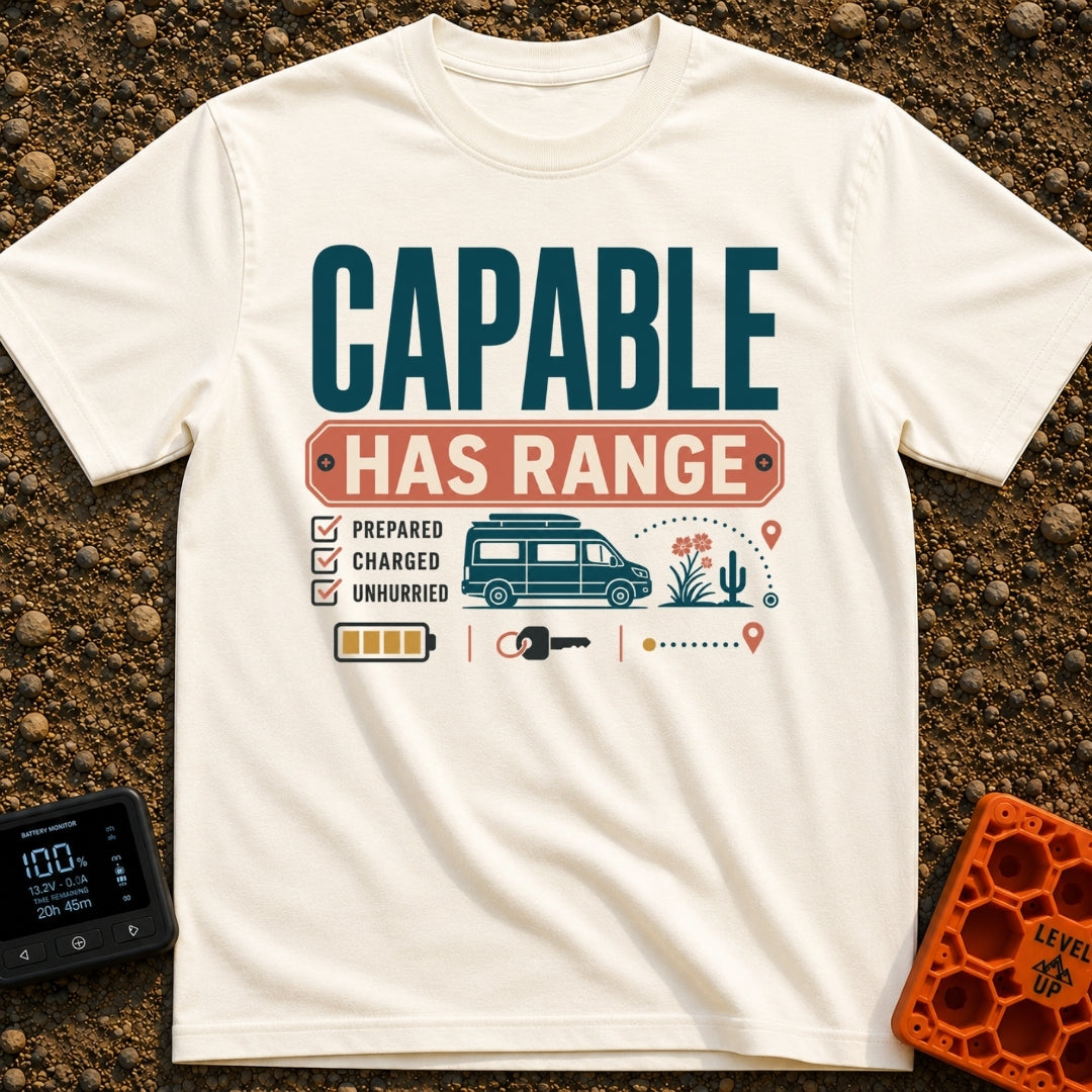 Charged And Capable - T-Shirt in Ivory - Typographical design reading "CAPABLE HAS RANGE" above a checklist featuring the...