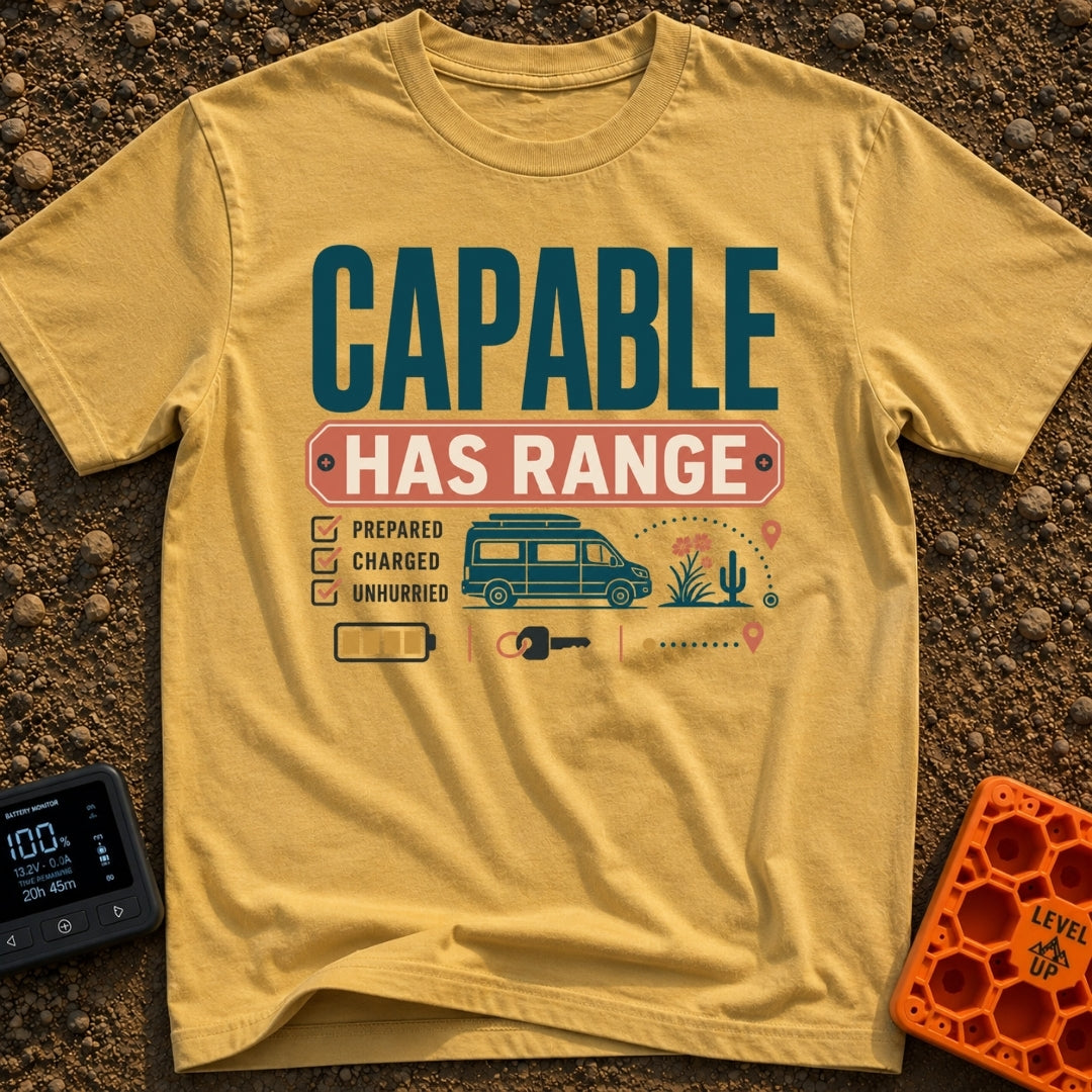 Charged And Capable - T-Shirt in Mustard - Typographical design reading "CAPABLE HAS RANGE" above a checklist featuring...