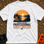 Professional Sunset Watcher - T-Shirt in White - An illustration of a person sitting in a camp chair on a rocky overlook,...