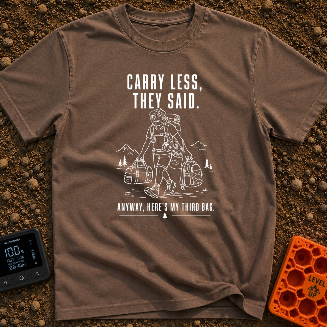 Pack Light They Said - T-Shirt in Espresso - A white line drawing of a tired man hiking past mountains and pine trees,...