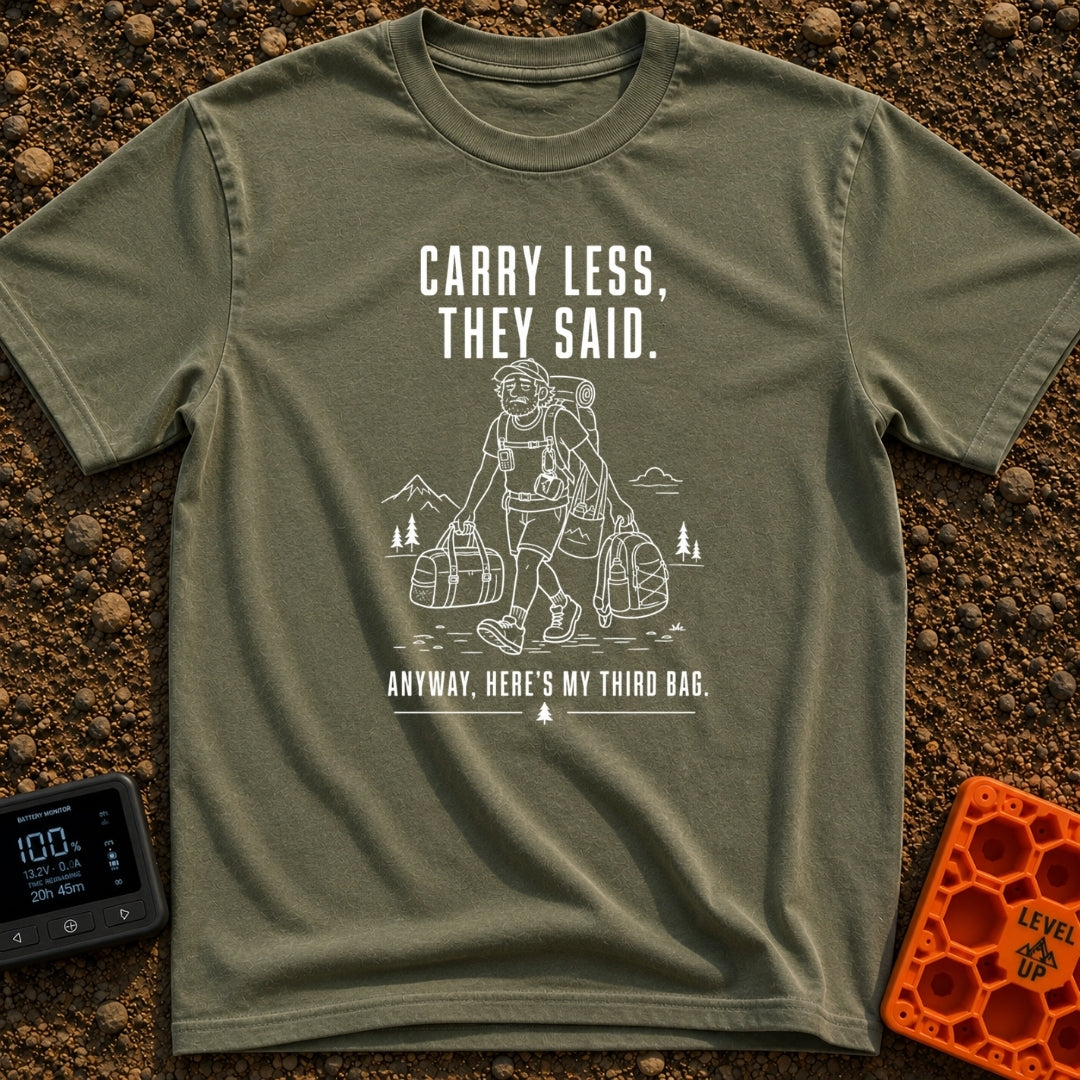 Pack Light They Said - T-Shirt in Moss - A white line drawing of a tired man hiking past mountains and pine trees,...