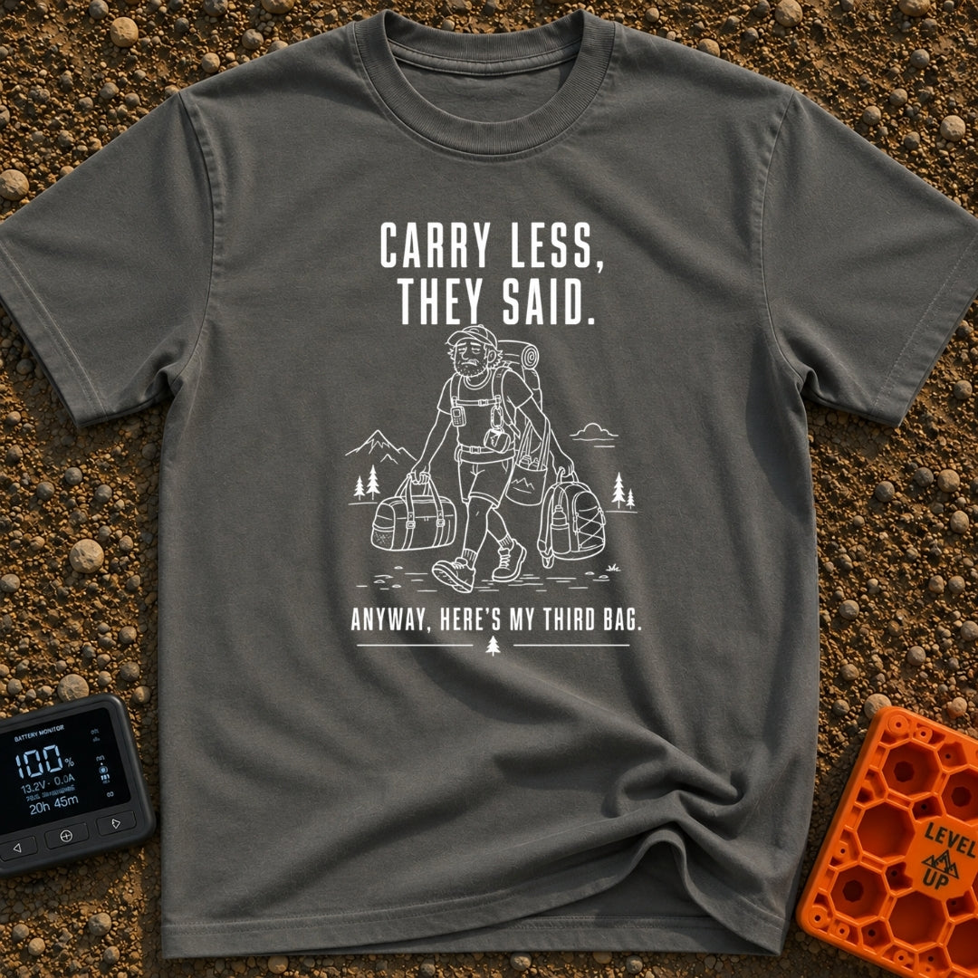 Pack Light They Said - T-Shirt in Pepper - A white line drawing of a tired man hiking past mountains and pine trees,...