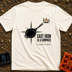Cast Iron Compass - T-Shirt in Ivory - A graphic featuring a black cast iron skillet superimposed over a multi-pointed...