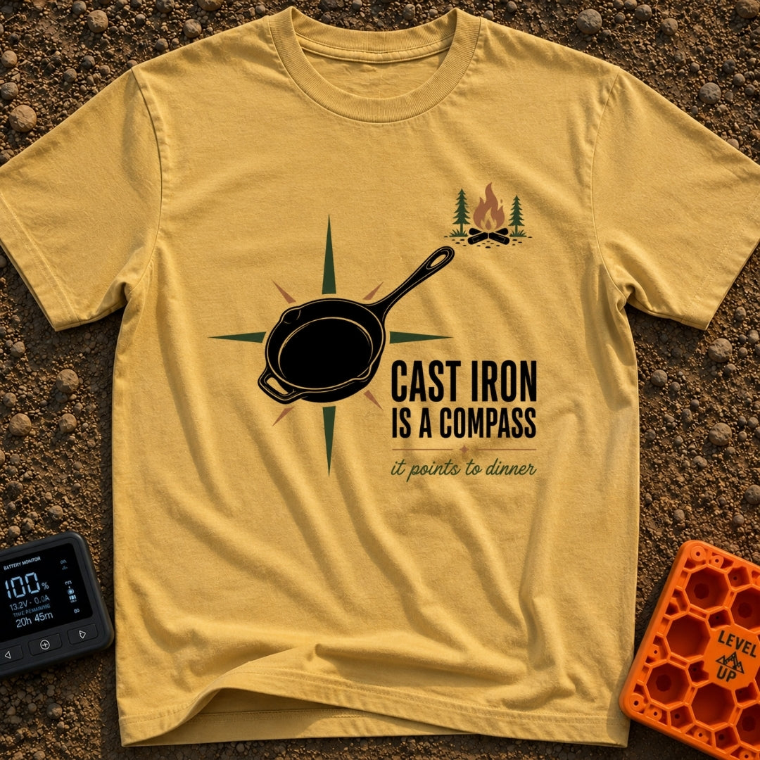 Cast Iron Compass - T-Shirt in Mustard - A graphic featuring a black cast iron skillet superimposed over a multi-pointed...