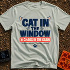 Chaos In The Cabin - T-Shirt in Bay - A typographic design featuring the text "CAT IN THE WINDOW" with stylized cat ears...