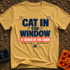 Chaos In The Cabin - T-Shirt in Mustard - A typographic design featuring the text "CAT IN THE WINDOW" with stylized cat...