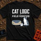 Cat Logic Certified - T-Shirt in Black - A black and white cat sitting upright next to an empty round pet bed, with a...