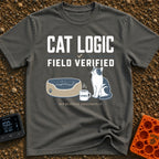 Cat Logic Certified - T-Shirt in Pepper - A black and white cat sitting upright next to an empty round pet bed, with a...