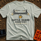 Cattle Guard Java - T-Shirt in Bay - A graphic showing a dirt road passing over a metal cattle guard between barbed wire...