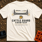 Cattle Guard Java - T-Shirt in Ivory - A graphic showing a dirt road passing over a metal cattle guard between barbed...