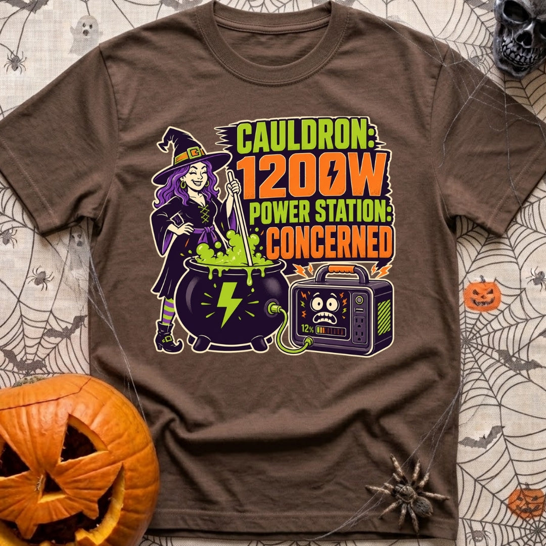 Watts In The Cauldron - T-Shirt in Espresso - A cartoon witch with purple hair stirs a bubbling green cauldron that is...