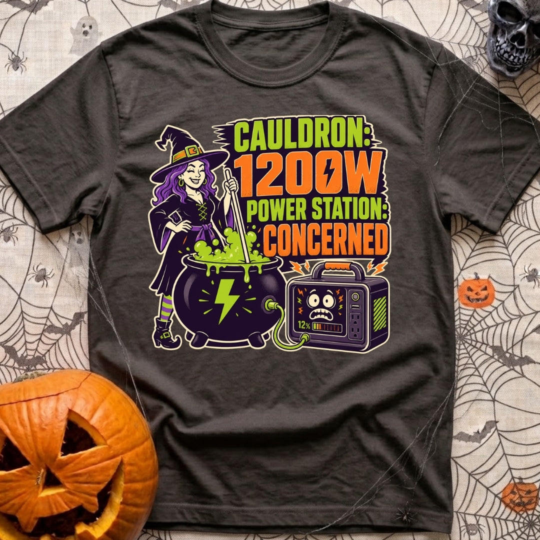 Watts In The Cauldron - T-Shirt in Graphite - A cartoon witch with purple hair stirs a bubbling green cauldron that is...