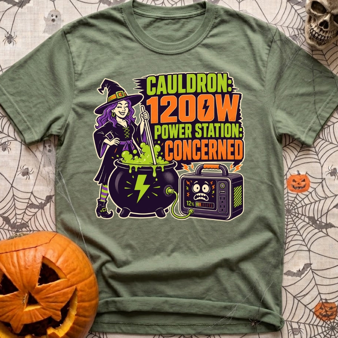 Watts In The Cauldron - T-Shirt in Moss - A cartoon witch with purple hair stirs a bubbling green cauldron that is...