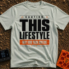 May Void Your Routine - T-Shirt in Bay - A typographic design styled like an industrial warning label featuring the large...