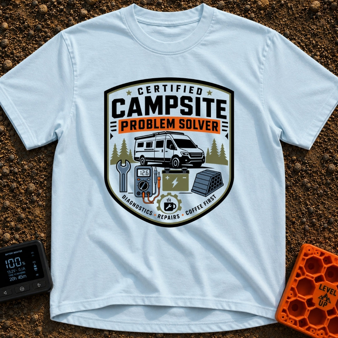 Campsite Crisis Wrangler - T-Shirt in Chambray - A badge-style illustration of a white camper van parked among pine...