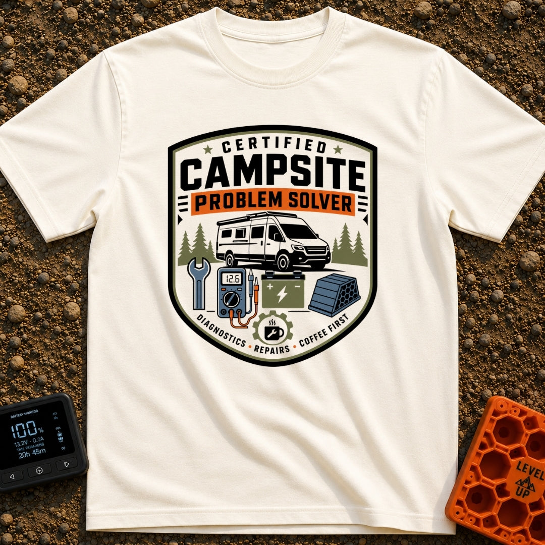 Campsite Crisis Wrangler - T-Shirt in Ivory - A badge-style illustration of a white camper van parked among pine trees,...